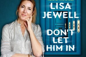 woman standing with hand to chin in front of a larger cover of her book